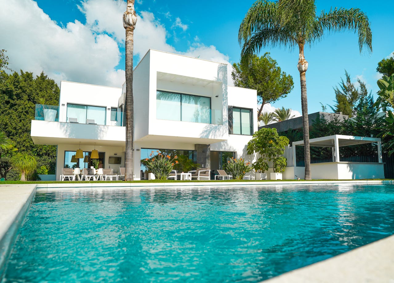 Crafting Captivating Headlines: Your awesome post title goes here A stunning modern luxury villa with a pool, surrounded by lush greenery and bathed in sunlight.