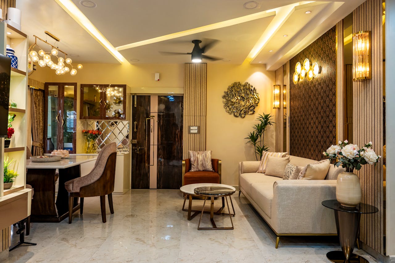 Luxurious living room with modern decor, beige sofa, marble flooring, and elegant lighting.